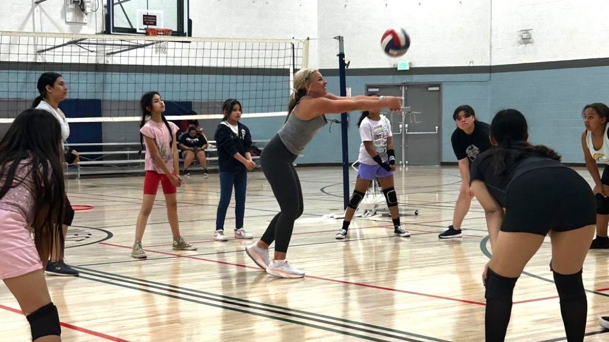 Girls and their coach playing volleyball during the first eight-week clinic launched in fall 2023.