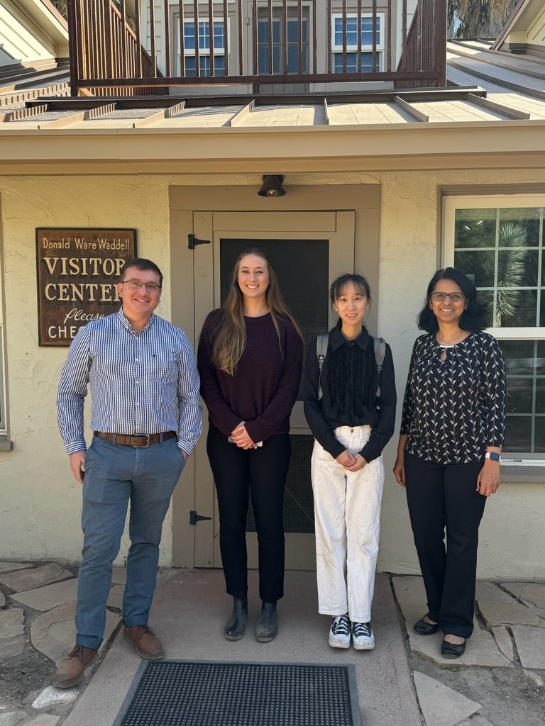 Dr. Nick Wise, undergrad student Katelyn Skabelund, PhD student Ziming Jin and Dr. Megha Budruk pose outside the Donald Ware Waddell Visitor Center